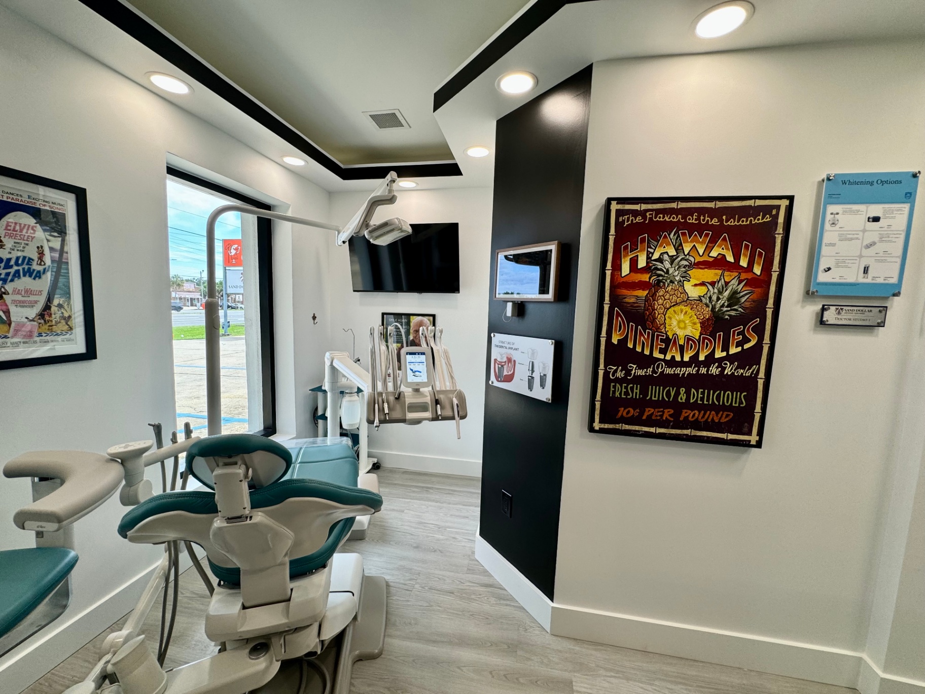 Treatment room with vintage Hawaii Pineapples poster and chairside monitor