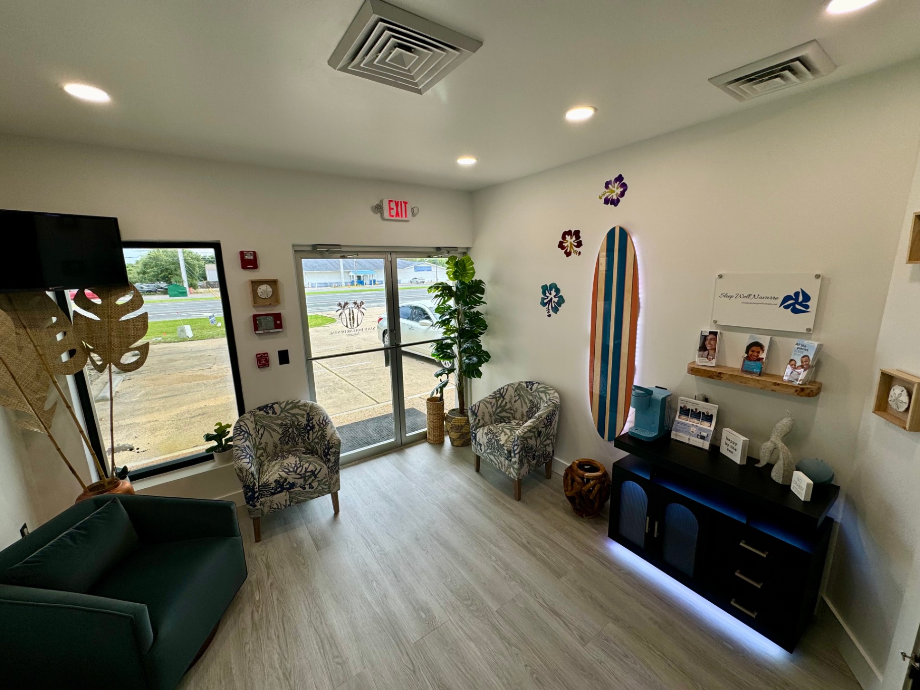 Comfortable waiting area with surfboard, plants, and coffee station